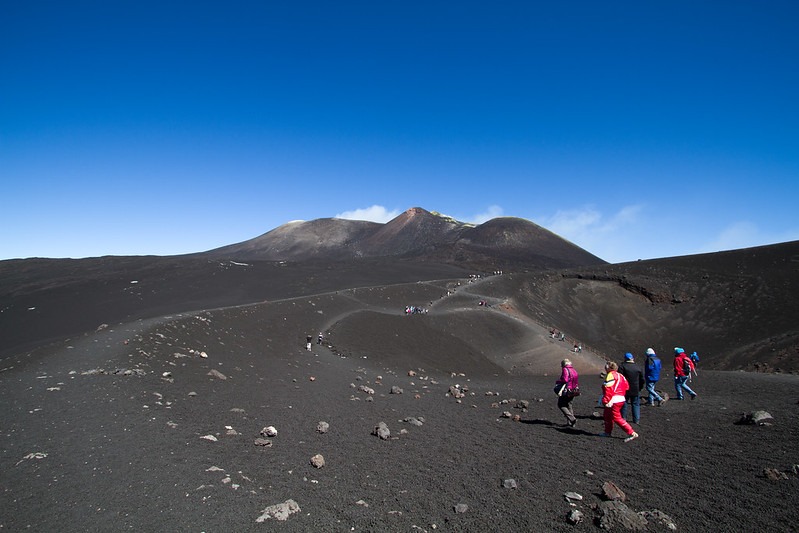 people hiking on mount etna