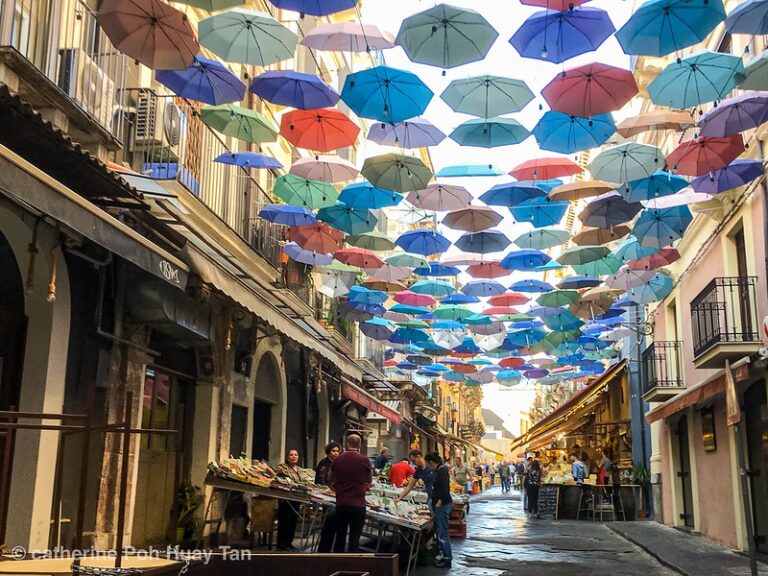 Colored umbrellas in a street market in Catania