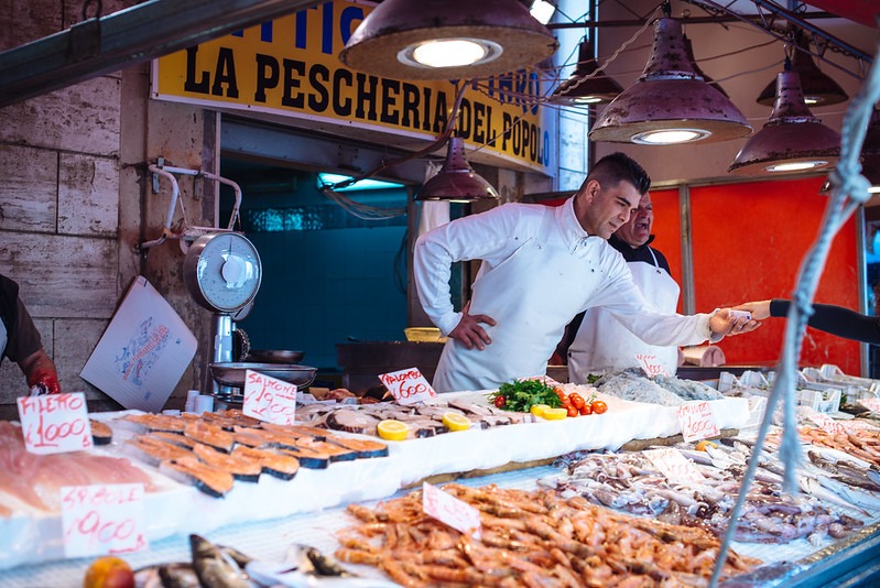 Fishmongers selling fresh fish in Ortigia's Market, Siracusa